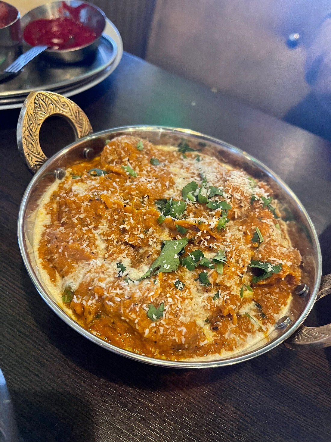 A rich, creamy Chicken Korma garnished with desiccated coconut and fresh 
coriander at MariGold restaurant in Kilmacolm. 